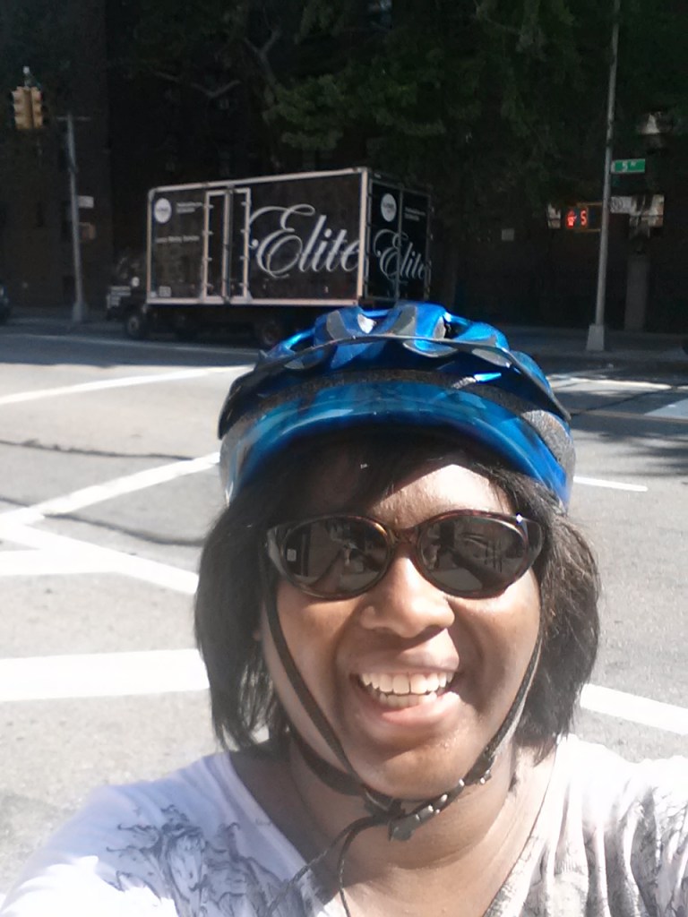 Me on moving day. The moving truck is behind me. I road my bike between the two apartments all that day. 